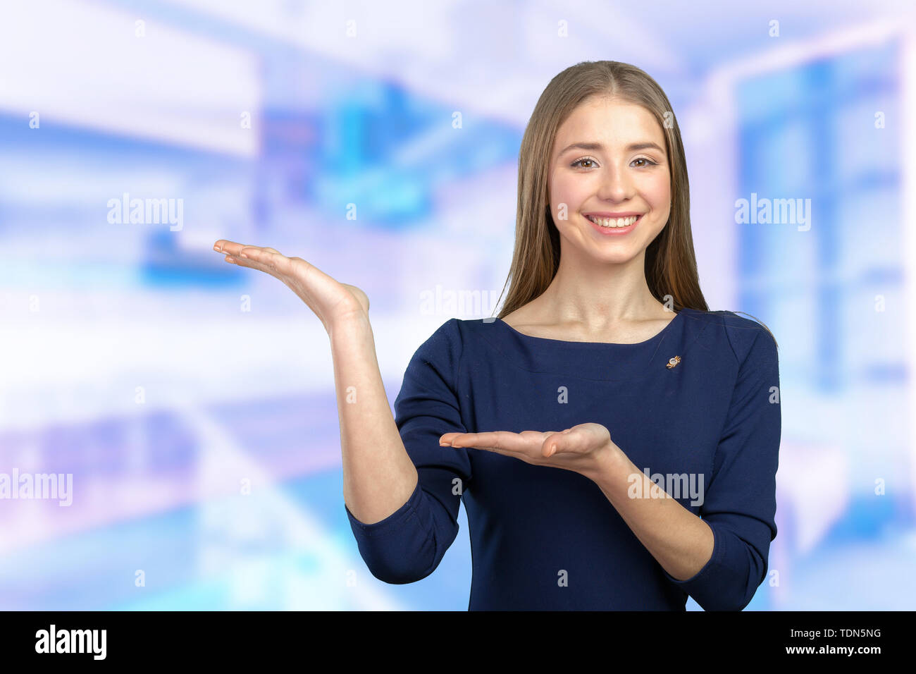 Beautiful happy smiling woman showing copy space Stock Photo - Alamy