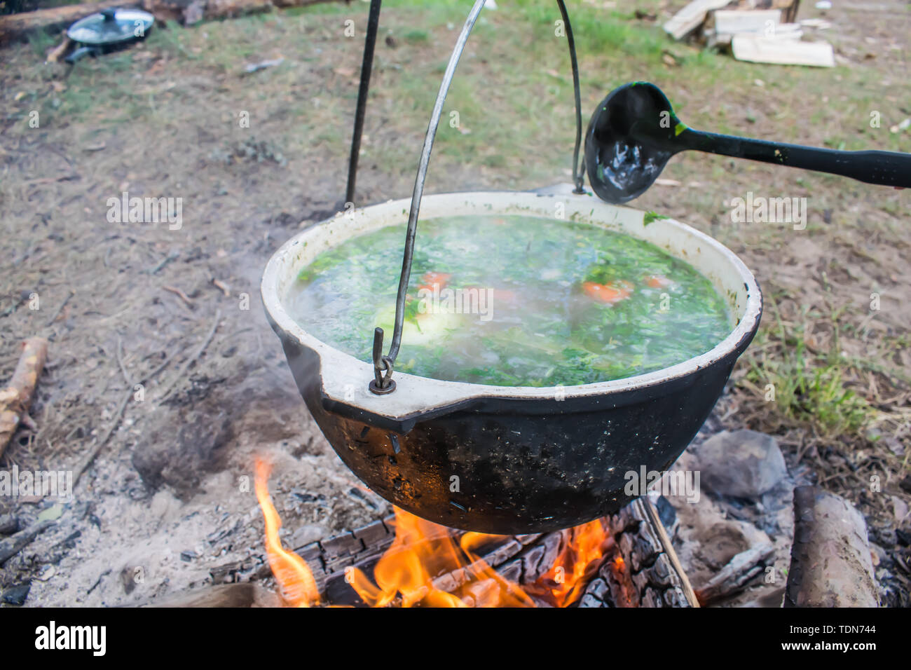 Fish in a frying pan over an outdoor fire Stock Photo - Alamy