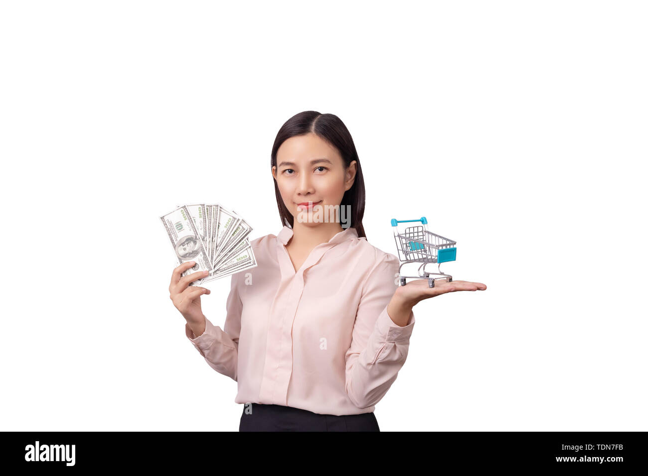 retail commercial business concept, Asian beautiful woman holding banknote money in hand and shopping cart in another hand isolated on white backgroun Stock Photo