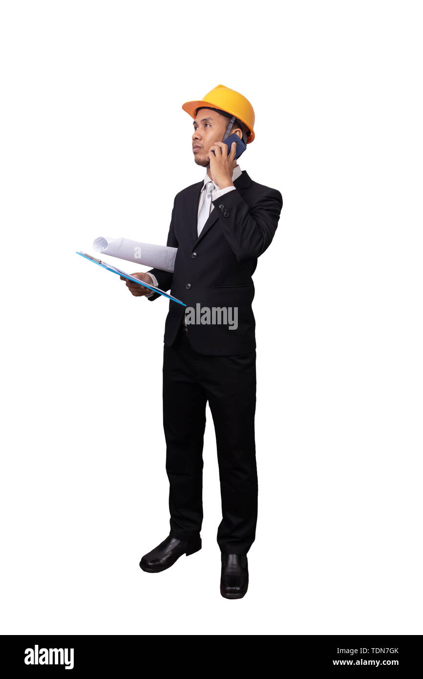 full portrait of Asian engineer man standing isolated on white background with clipping path. engineer with yellow safety helmet have blueprint in han Stock Photo