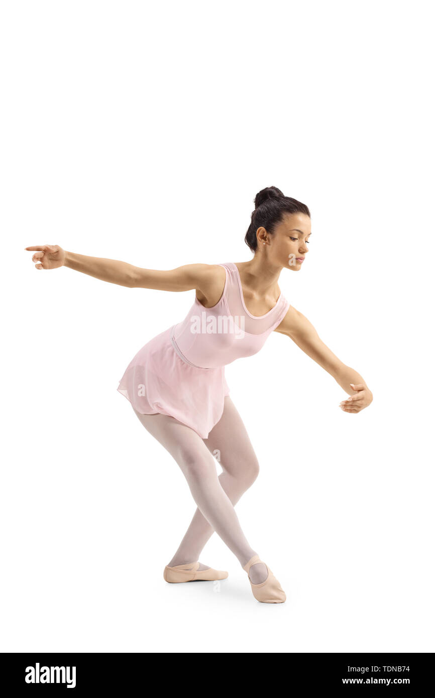 A wooden mannequin in a ballet pose, on it's base, on a white