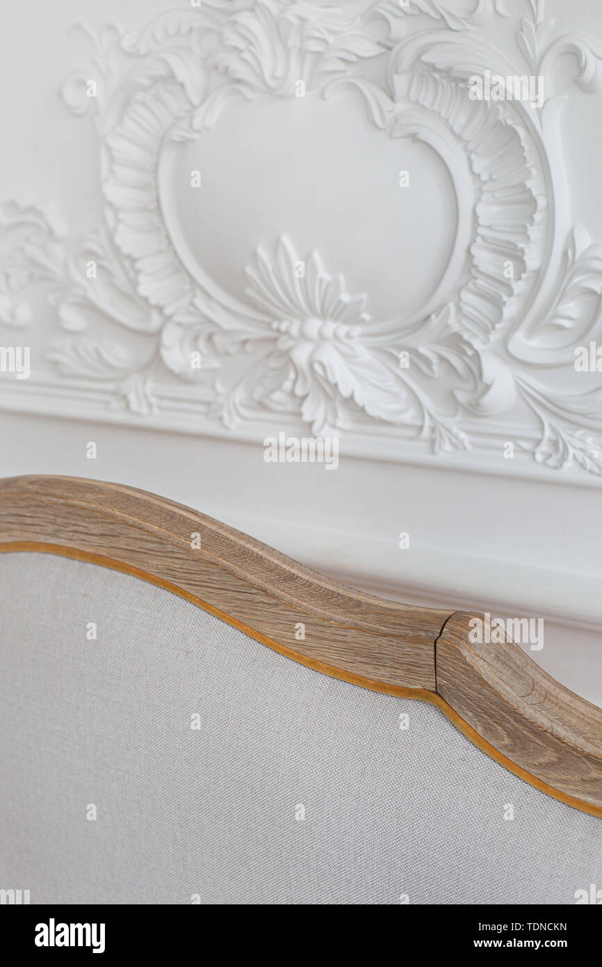 Luxurious bright Rococo interior with a large sofa and stucco on the ...
