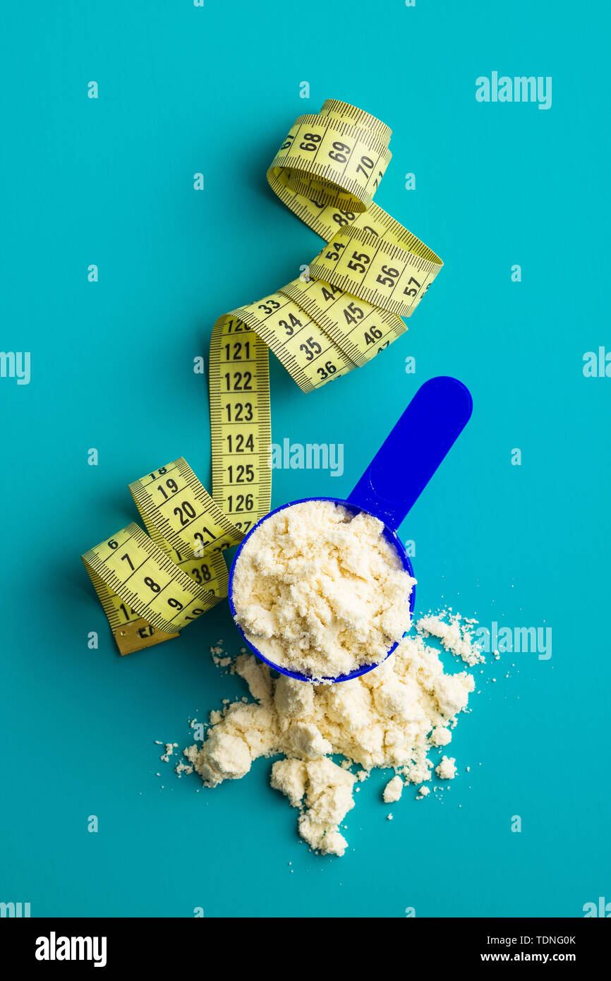 Whey Protein Powder In Scoop And Measuring Tape Top View Stock