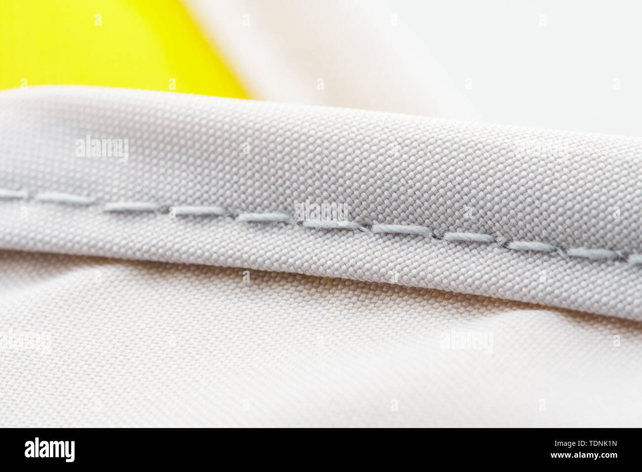 Finishing seam of a sports backpack closeup shot. Sport nylon fabric