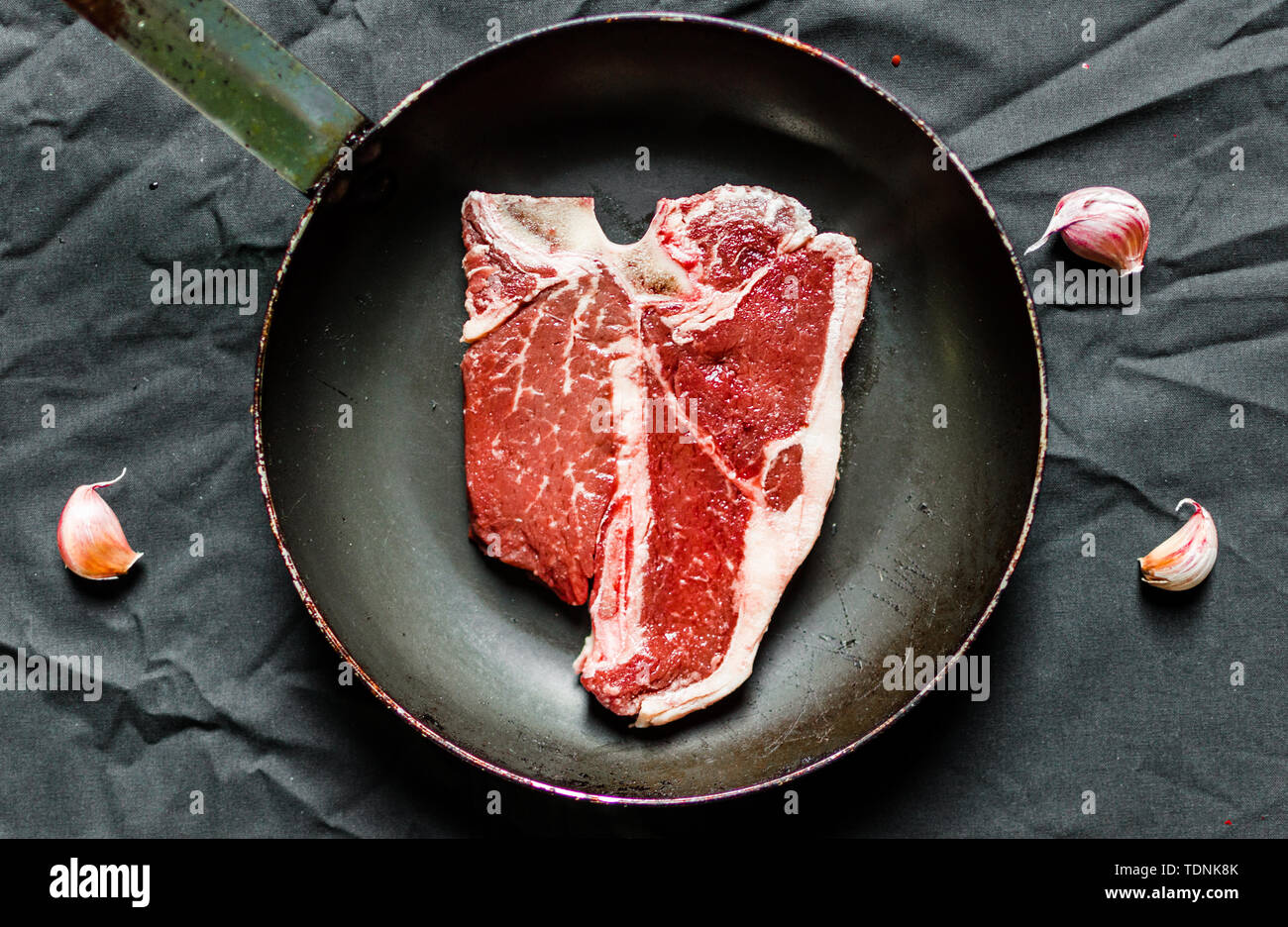 T bone steak of beef meat against black background Stock Photo Alamy