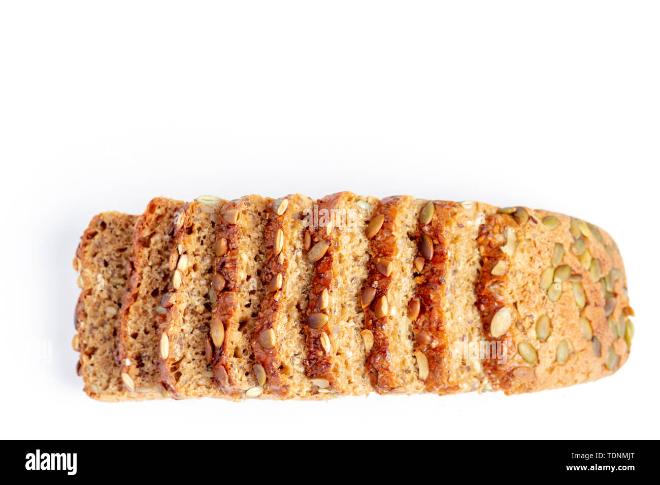 Slice of multigrain bread with sunflower and pumpkin seeds and flax seed on a white background Stock Photo
