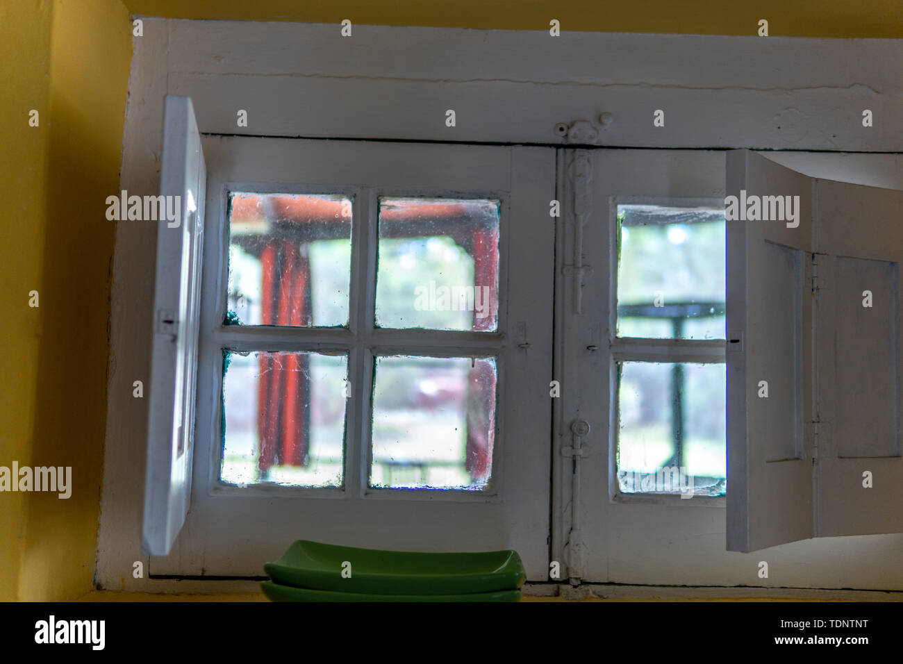 Looking through 100 year old white windows on sunny day Stock Photo