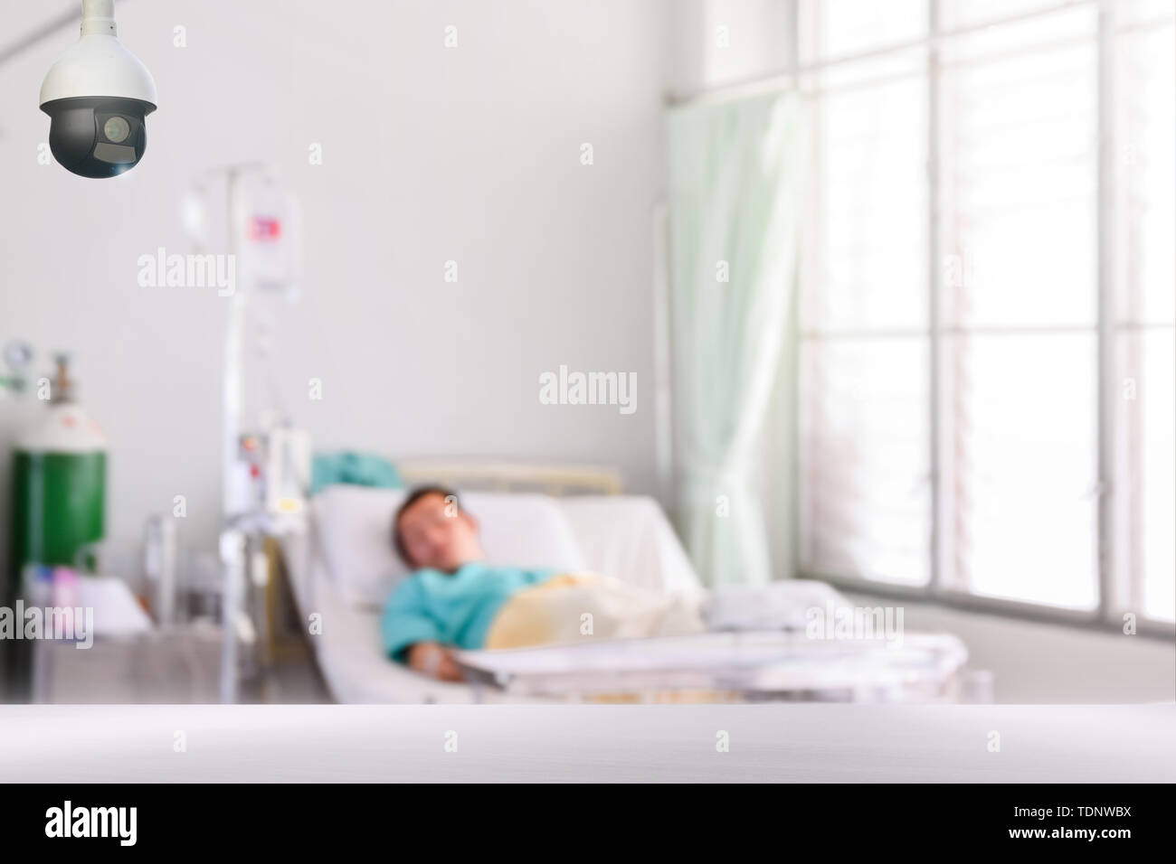 cctv camera with blurred patient in isolation room for monitor patient safety nurse or doctor for infection control Stock Photo