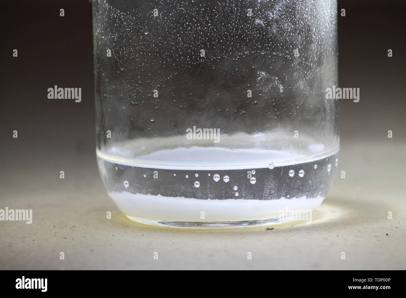 Closeup of a vinegar and baking soda reaction happening in the bottom