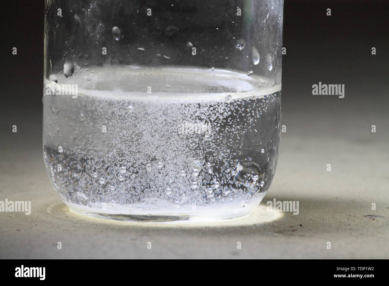 Closeup of a vinegar and baking soda reaction happening in the bottom