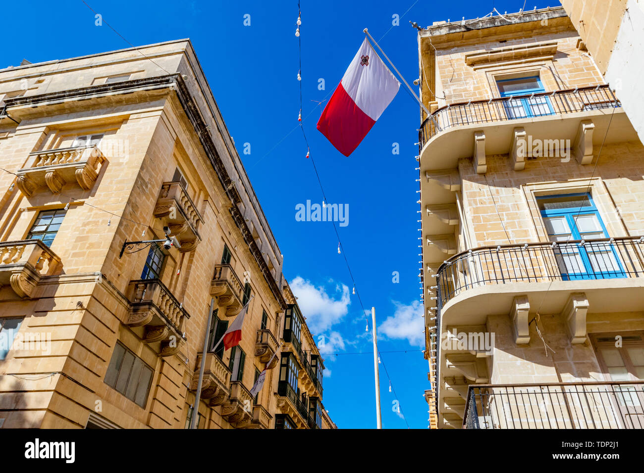 Typical narrow maltese streets with colorful traditional windows and