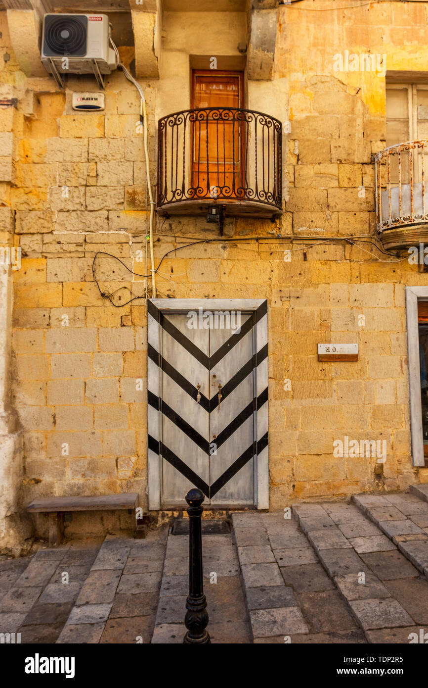 Typical narrow maltese streets with colorful traditional windows and