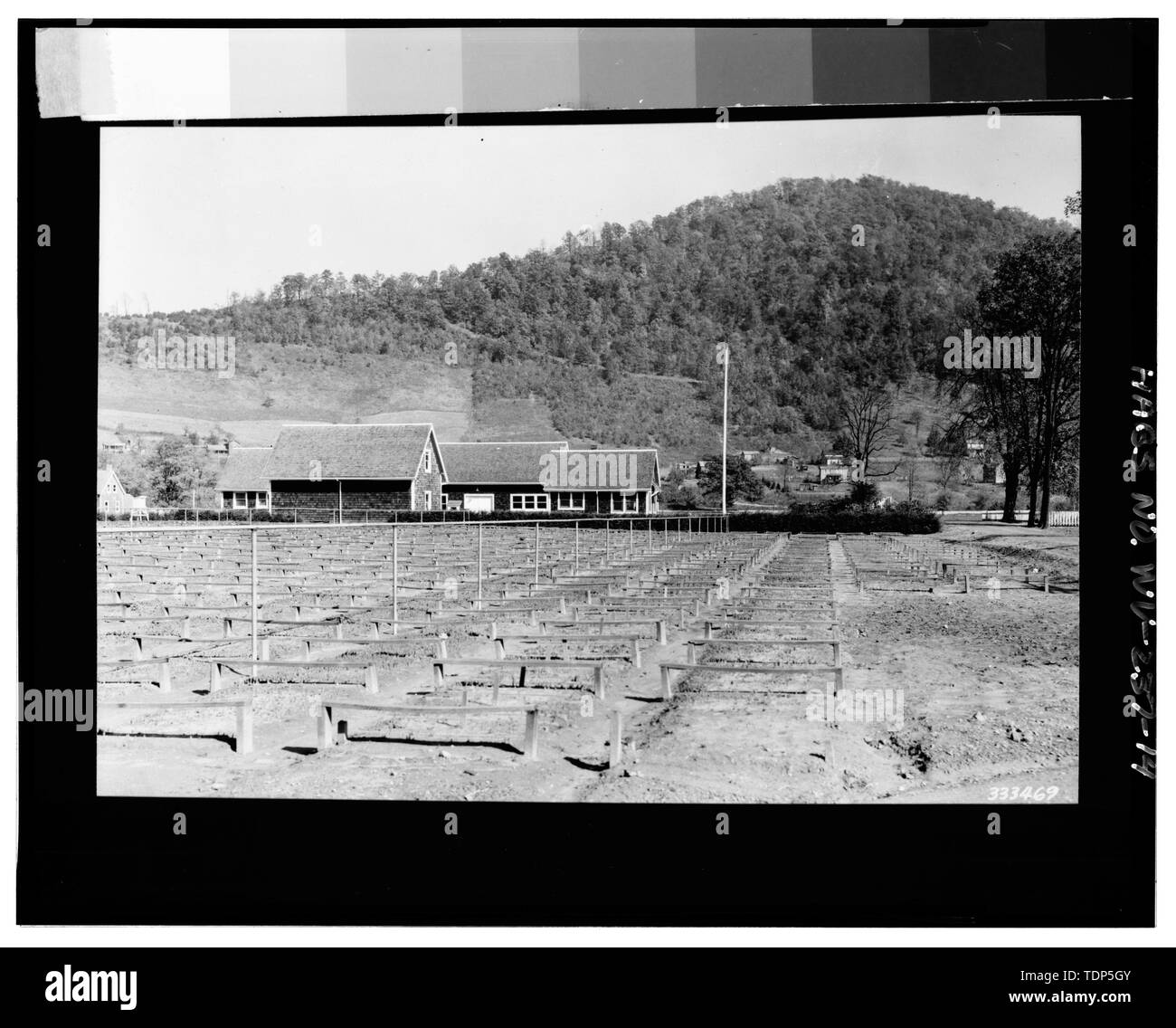 Photo copy of photograph, (original in Forest Service Office, Elkins, WV, photo -333469, 'Tree nurseries-seed bed preparation'), D. A. Oliver, November 1936. VIEW NORTHEAST, ORIGINAL WASH HOUSE, GARAGE (DEMOLISHED), WORKSHOP-WAREHOUSE, AND NURSERY OFFICE. - Parsons Nursery, South side of U.S. Route 219, Parsons, Tucker County, WV Stock Photo