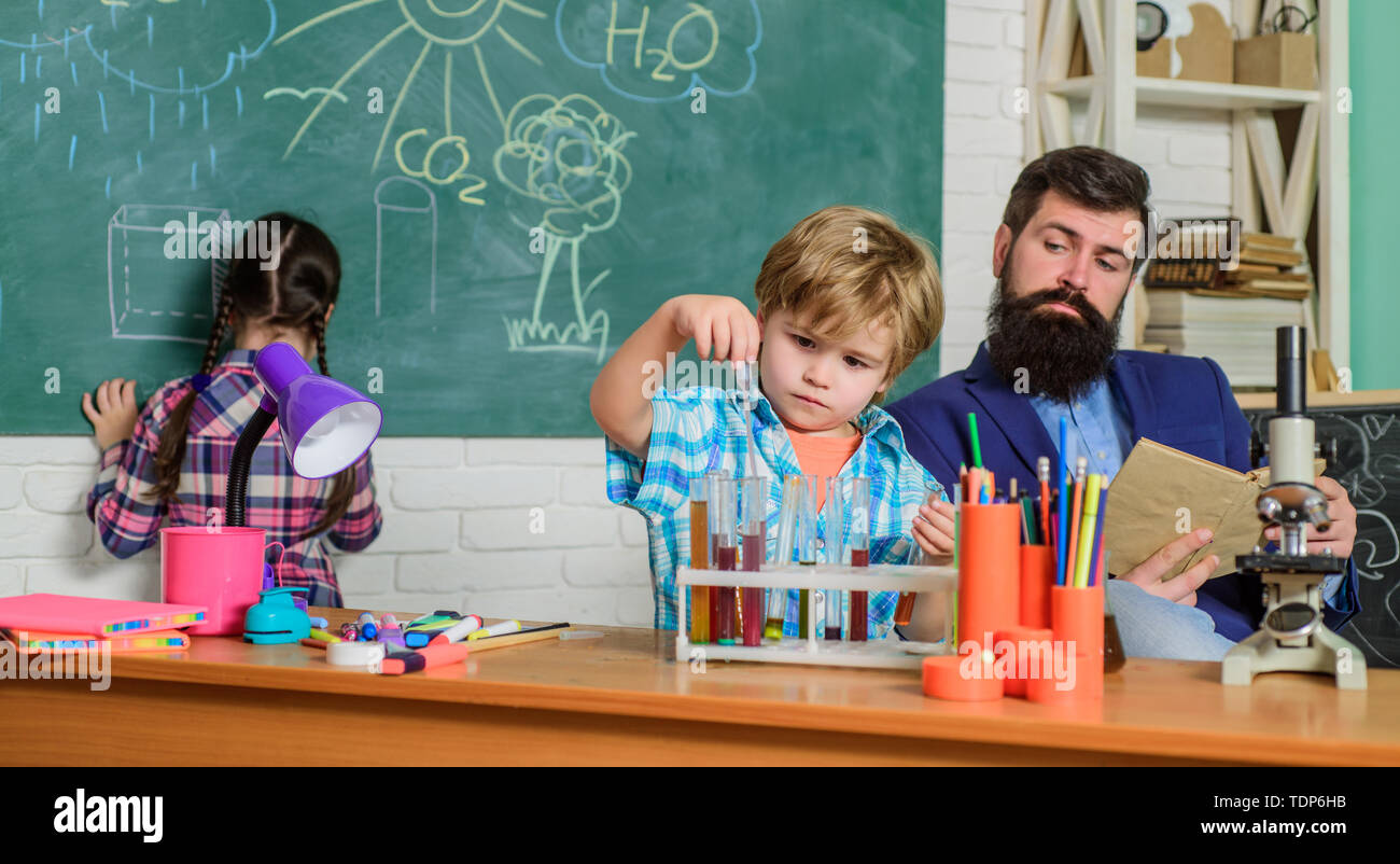 Science and education. chemistry lab. back to school. happy children teacher. children making science experiments. Education. doing experiments with liquids in chemistry lab. Hard choice. Stock Photo