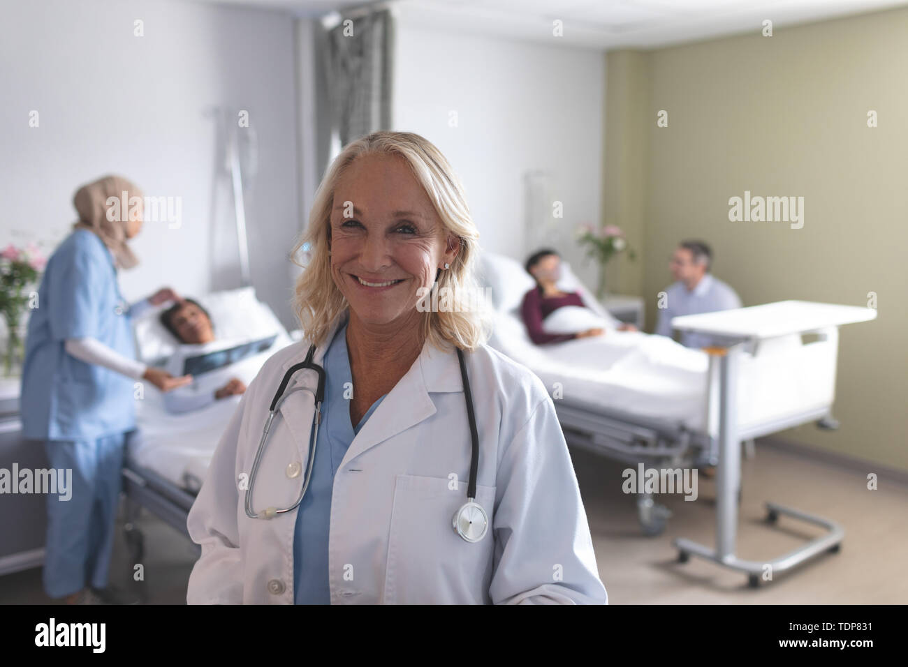 Female doctor smiling in the ward at hospital Stock Photo
