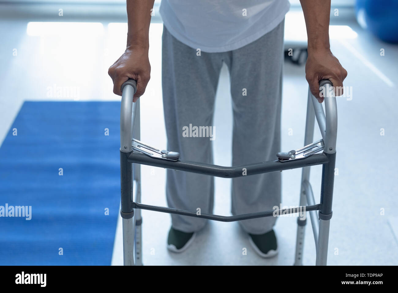 Male patient walking with walker in the ward at hospital Stock Photo