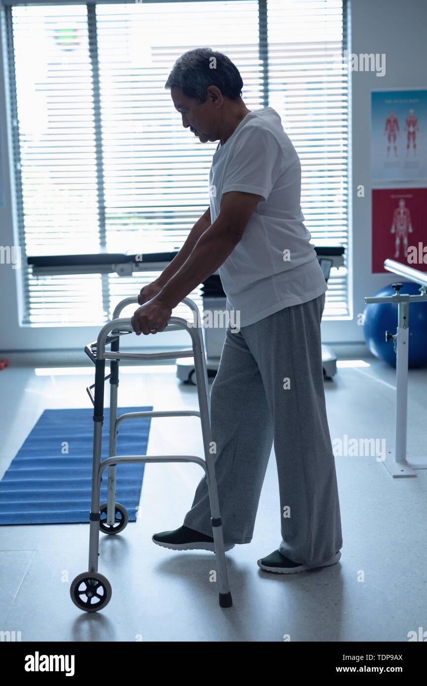 Male patient walking with walker in the ward Stock Photo Alamy