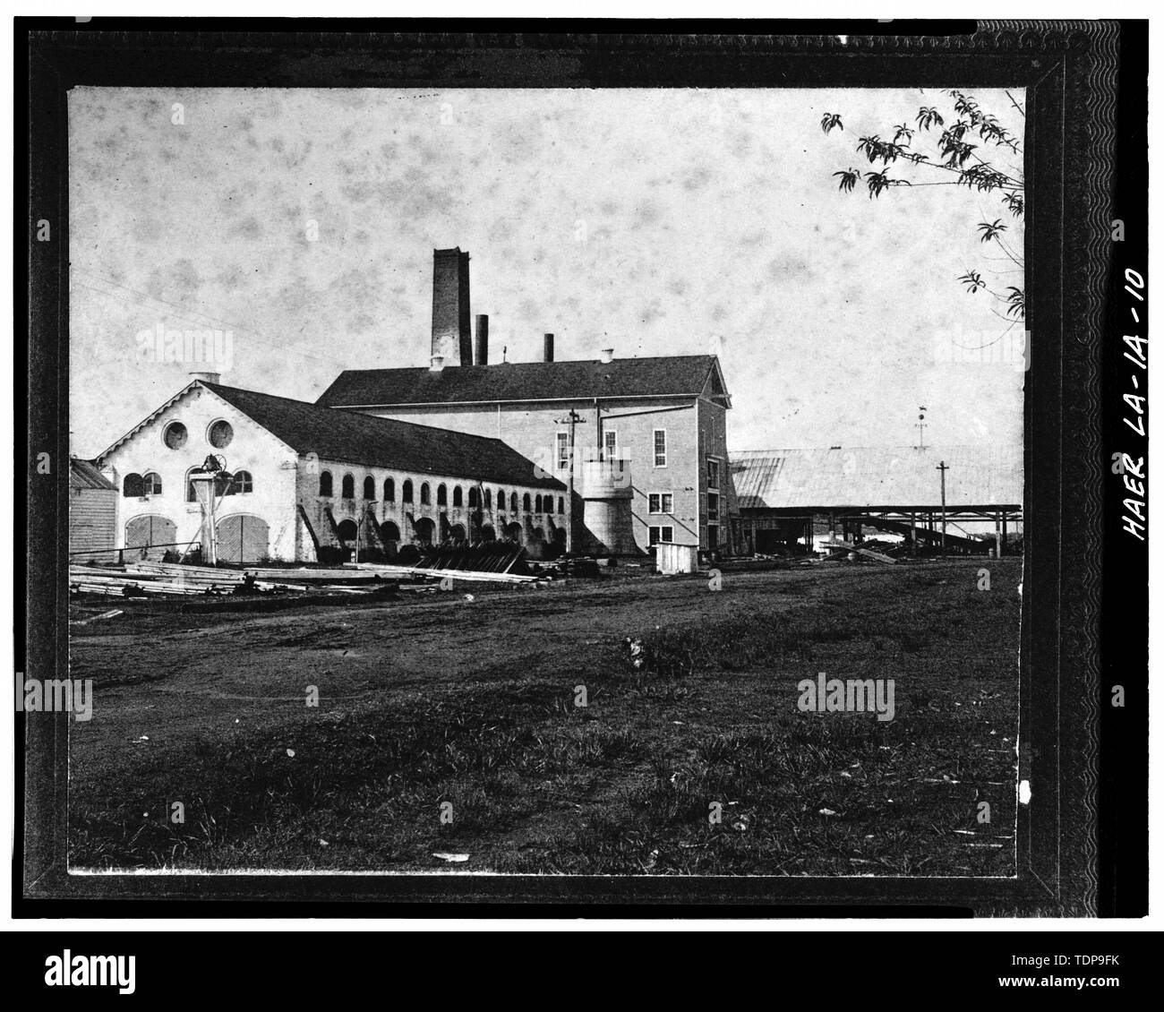 Photocopy of c. 1912 photograph looking N showing original c. 1845 brick mill with c. 1897 3-story, wood-frame addition at end; cane shed extends out to the left. - Laurel Valley Sugar Plantation, Sugar Mill, 2 miles South of Thibodaux on State Route 308, Thibodaux, Lafourche Parish, LA; Barker-Lepine; Behan and Zuberbier; Barker, Frank; Bush, Louis; De Bore, Etienne; Edwards, Daniel; Edwards, Jas D; Edwards, James D; Lepine, J Wilson; Mendez, Antonio; Rillieux, Norbert; Tucker, Joseph; Tucker, Joseph Pennington; Wormald, Burch; Lowe, Jet; Rumm, John C; Jandoli, Liz, transmitter Stock Photo