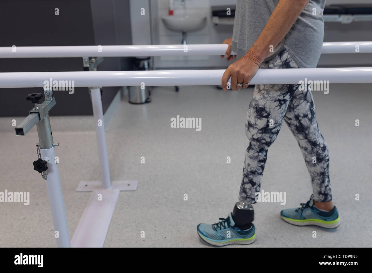 Female patient walking with parallel bars in hospital Stock Photo Alamy