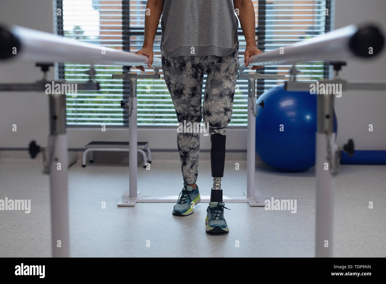 Female patient walking with parallel bars in hospital Stock Photo Alamy
