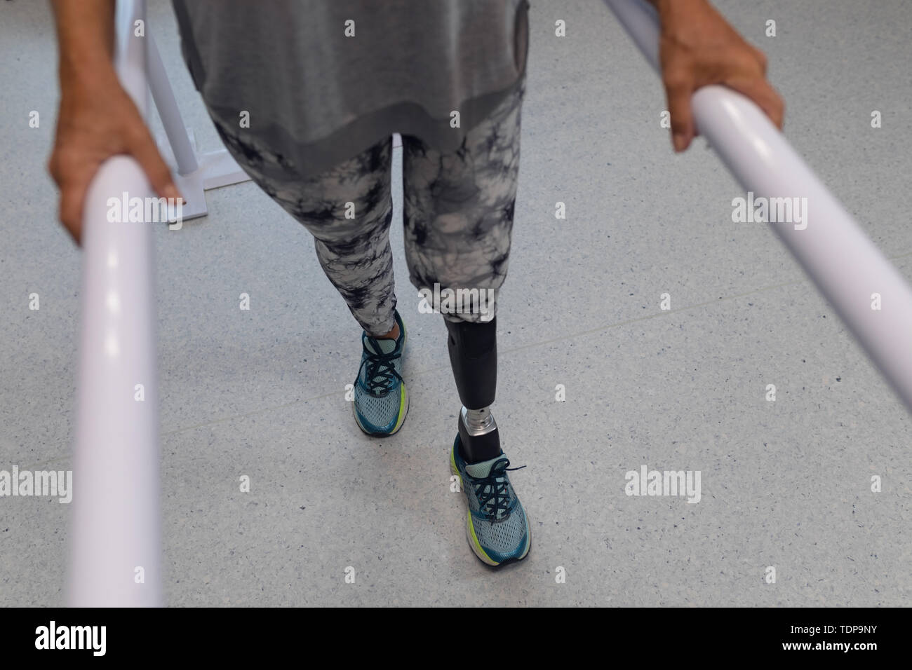 Female patient walking with parallel bars in hospital Stock Photo Alamy