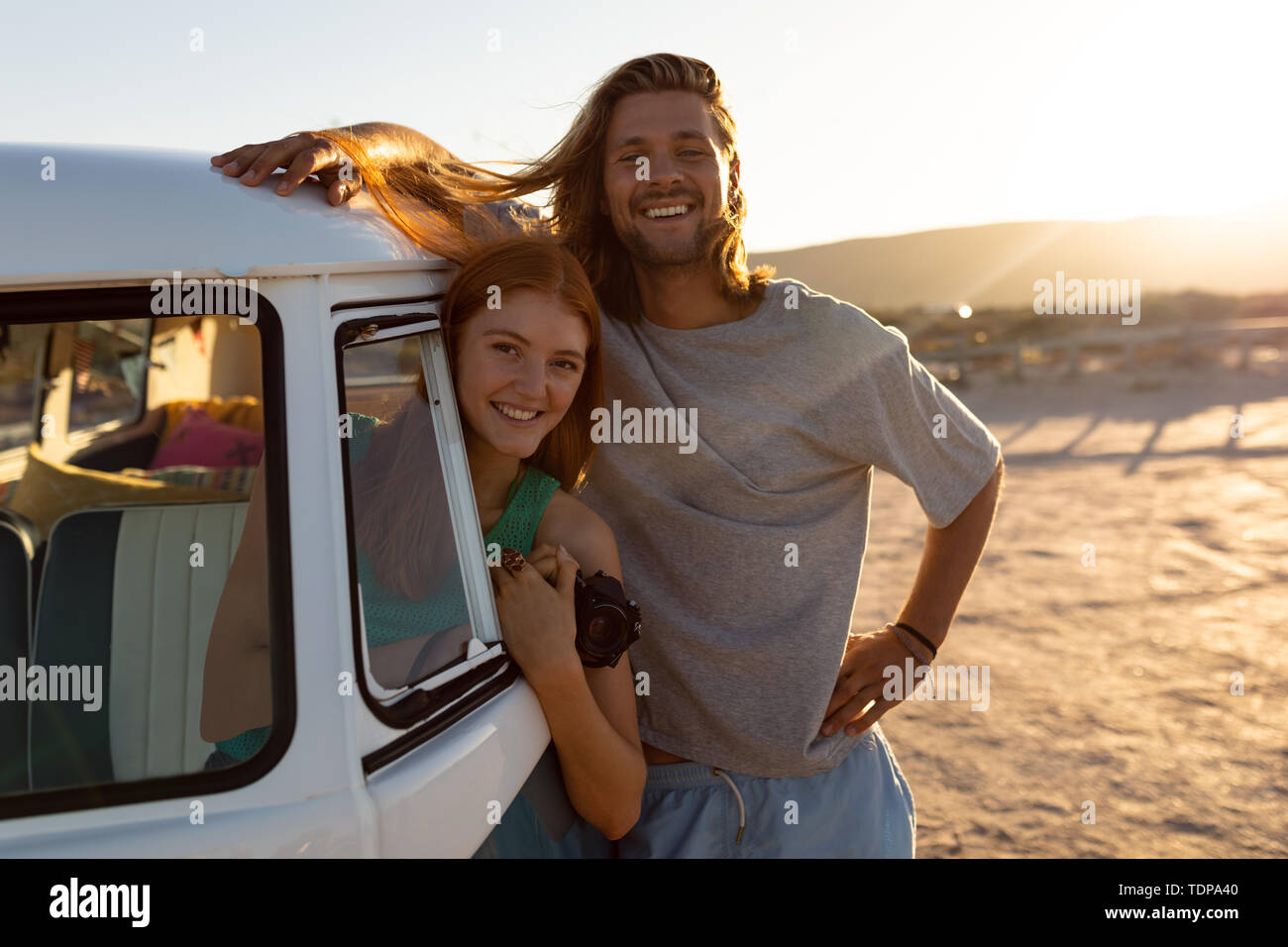 Woman leaning out of window while man standing beside her Stock Photo