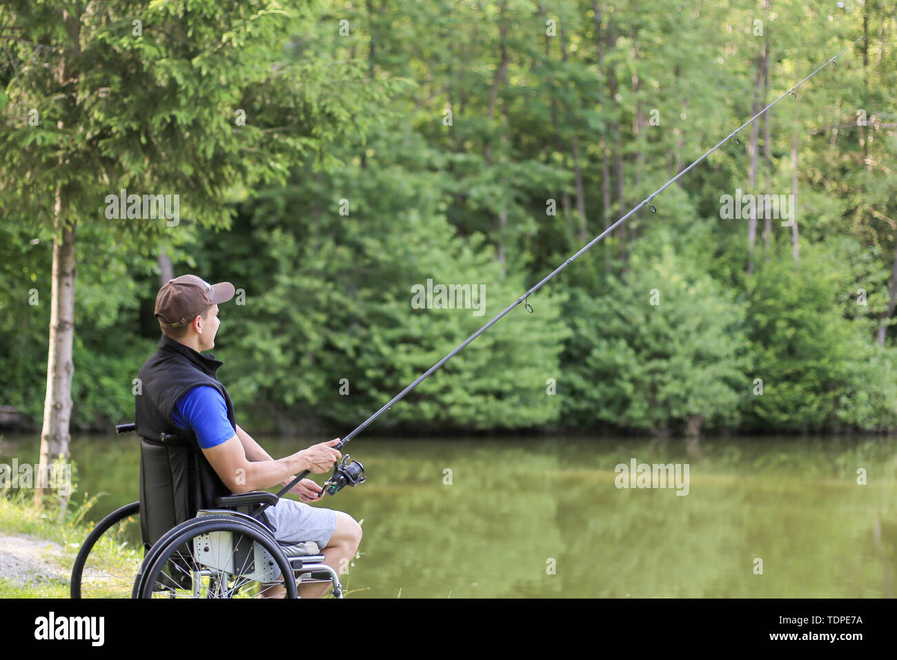 Fishing as an accessible competitive sport for people with disabilities and  also enjoying in nature for health benefits Stock Photo - Alamy