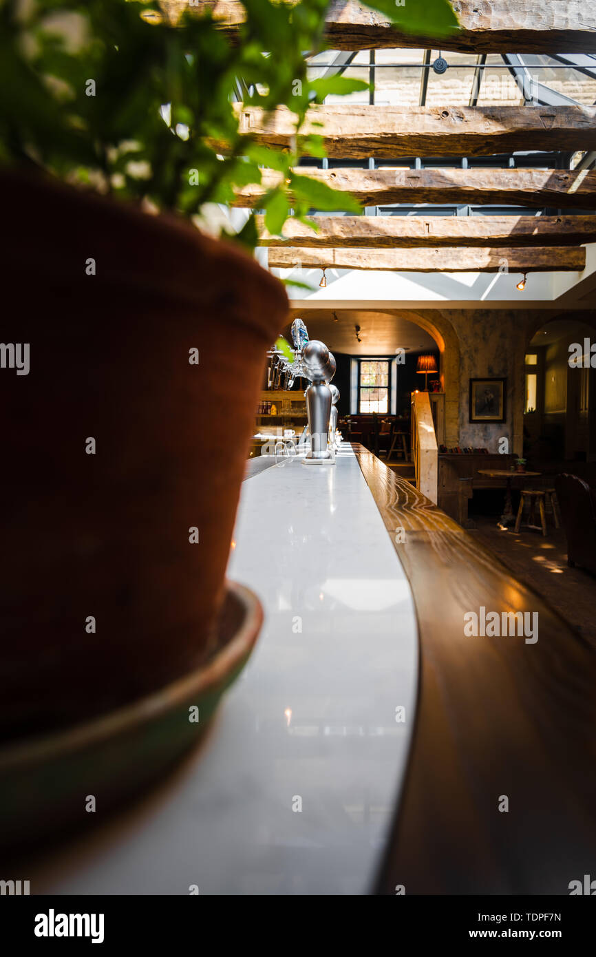 Empty british pub looking down at the pumps, tables and chairs. Stock Photo