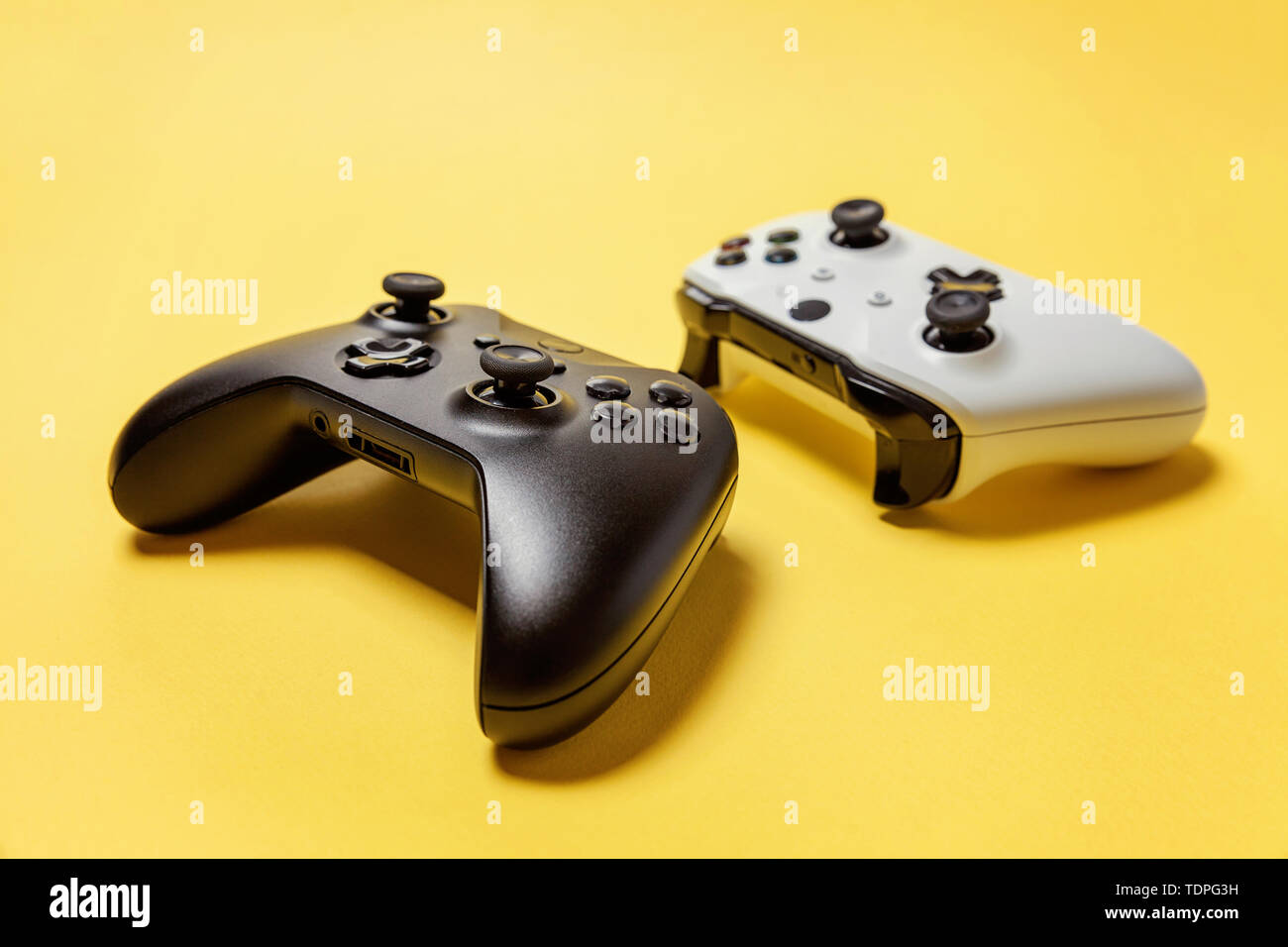 White and black two joystick gamepad, game console on yellow colourful ...