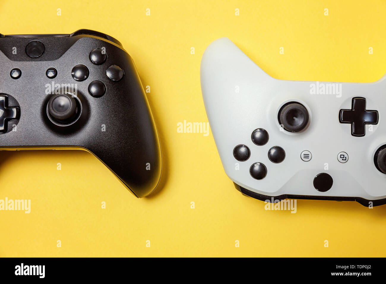 White and black two joystick gamepad, game console on yellow colourful ...