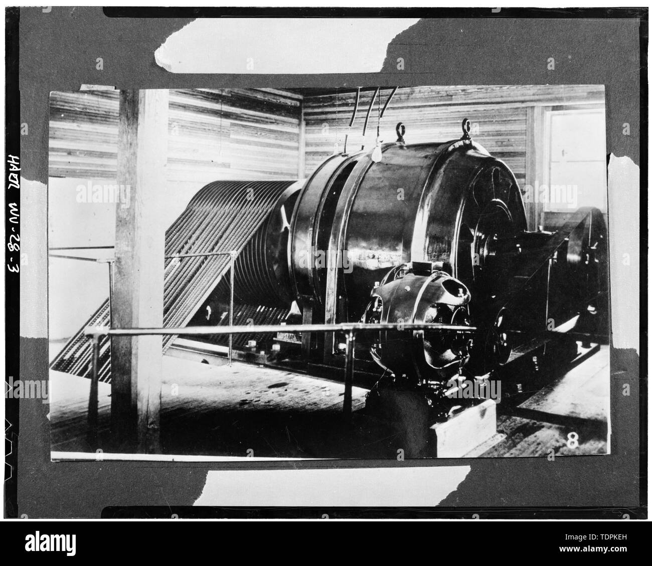c. 1904. INTERIOR OF ORIGINAL POWER HOUSE, SHOWING A ROPE DRIVEN WARREN 450  KW, 12,000 VOLT (LATER REWOUND TO 2,200 VOLT), 3 PHASE, 60 CYCLE, A.C.  GENERATOR, WITH BELT-DRIVEN WARREN 7-1-2 KW,