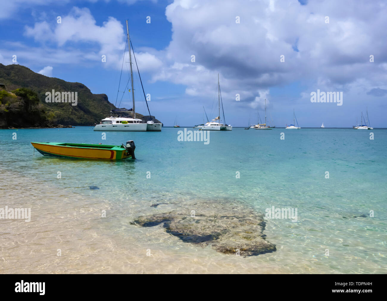 Boat and catamarans moored off Princess Margaret Beach, Bequia, near St Vincent; Saint Vincent and the Grenadines Stock Photo