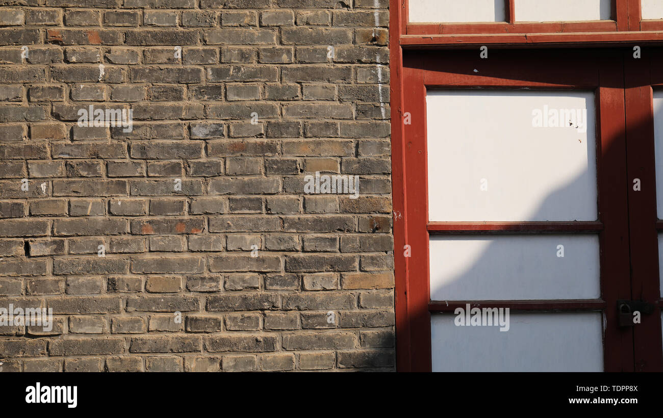 Nostalgic brick walls, mottled tree shadows Stock Photo