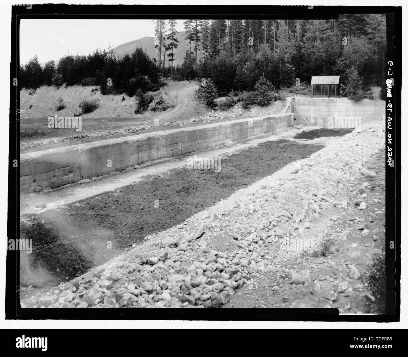 Photographic copy of photograph, G.G. Rollstin, photographer, 27 July 1936 (original print located at U.S. Bureau of Reclamation Upper Columbia Area Office Yakima, Washington). SHOWING EXCAVATION OF CONCRETE AND RUBBLE PAVING IN OLD SPILLWAY CHANNEL, LOOKING WEST - Kachess Dam, Dike Closing 1913 Spillway, Kachess River, 1.5 miles north of Interstate 90 , Easton, Kittitas County, WA Stock Photo