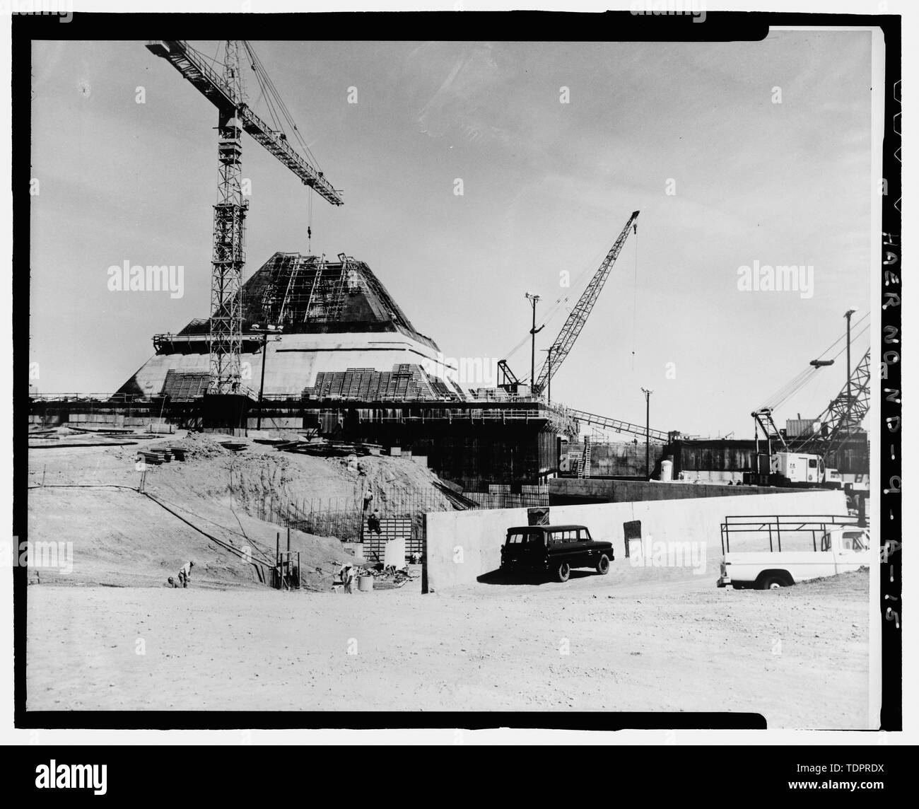 Photographic copy of photograph, dated 30 August 1971 (original print in possession of CSSD-HO, Huntsville, AL). Photographer unknown. View (southwest to northeast) of missile site control building. Of particular interest is the uncompleted subterranean portion and the workers, who give an indication of the actual scale of the building. In the foreground can be seen the beginning of the heat sink - Stanley R. Mickelsen Safeguard Complex, Missile Site Control Building, Northeast of Tactical Road; southeast of Tactical Road South, Nekoma, Cavalier County, ND Stock Photo
