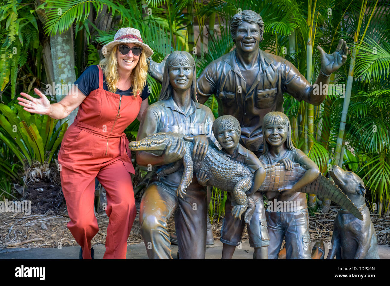 Tourist with statue of Irwin family at the zoo; Beerway, Queensland, Australia Stock Photo