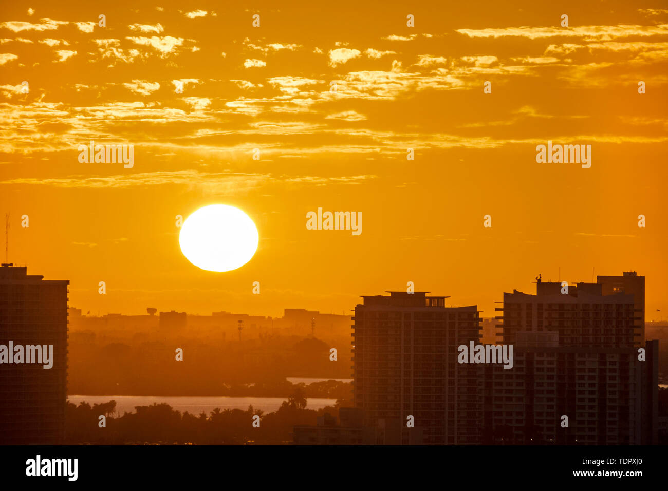 Miami Florida,North Bay Village Island,sunset,city skyline,amber color sky,setting sun,FL190104060 Stock Photo