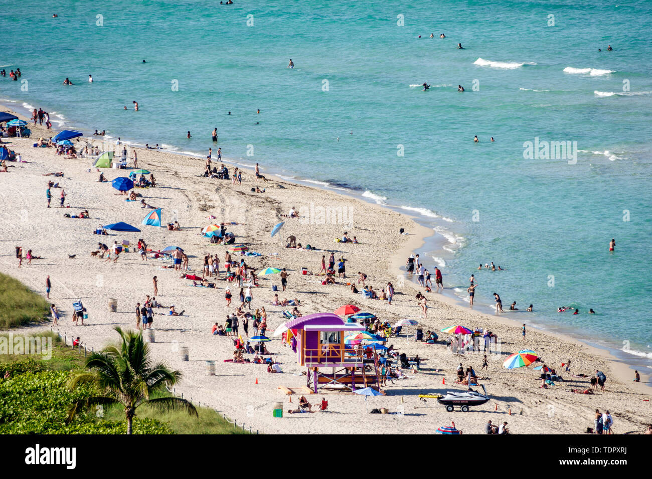 Miami Beach Florida,North Beach,North Shore Open Space Park,Atlantic Ocean,sunbathers,public beach,sand,umbrellas,shoreline,lifeguard tower station,cr Stock Photo