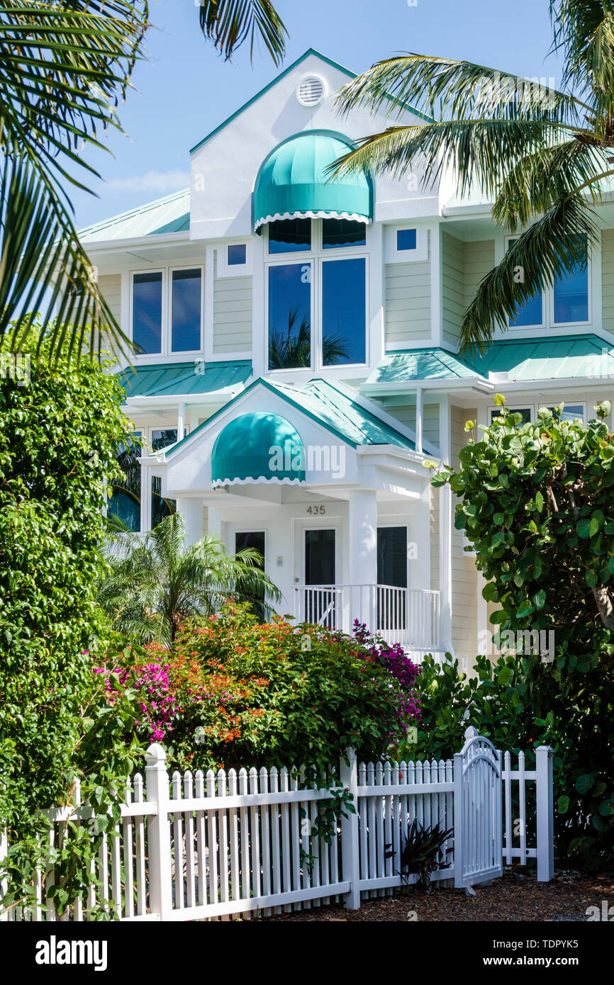 Sanibel Island Florida,East Gulf Drive,home,large beach house,white picket fence,exterior,awning,tropical vegetation,garden,FL190508033 Stock Photo