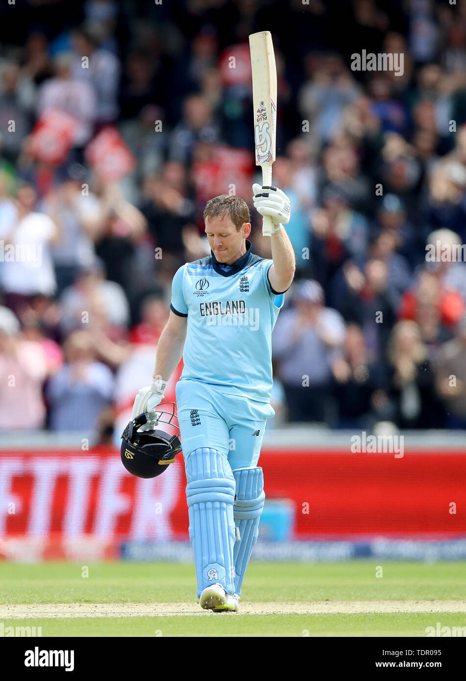 England's Eoin Morgan raises his bat after reaching a century during the ICC Cricket World Cup group stage match at Old Trafford, Manchester. Stock Photo