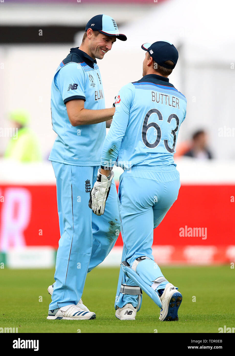 England's Jos Buttler (right) celebrates with Chris Woakes (right) after catching Afghanistan's Gulbadin Naib out, bowled by Mark Wood (not in picture), during the ICC Cricket World Cup group stage match at Old Trafford, Manchester. Stock Photo