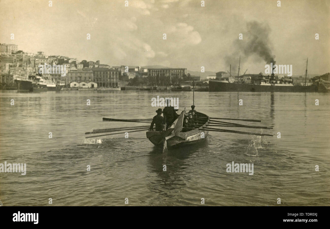 Sailors rowing a small boat in the port, Italy 1930s Stock Photo