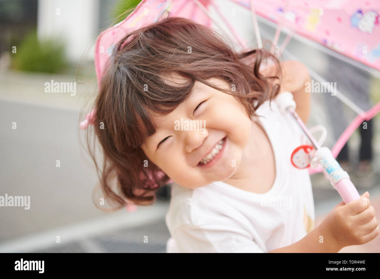 Japanese kid outside with umbrella Stock Photo