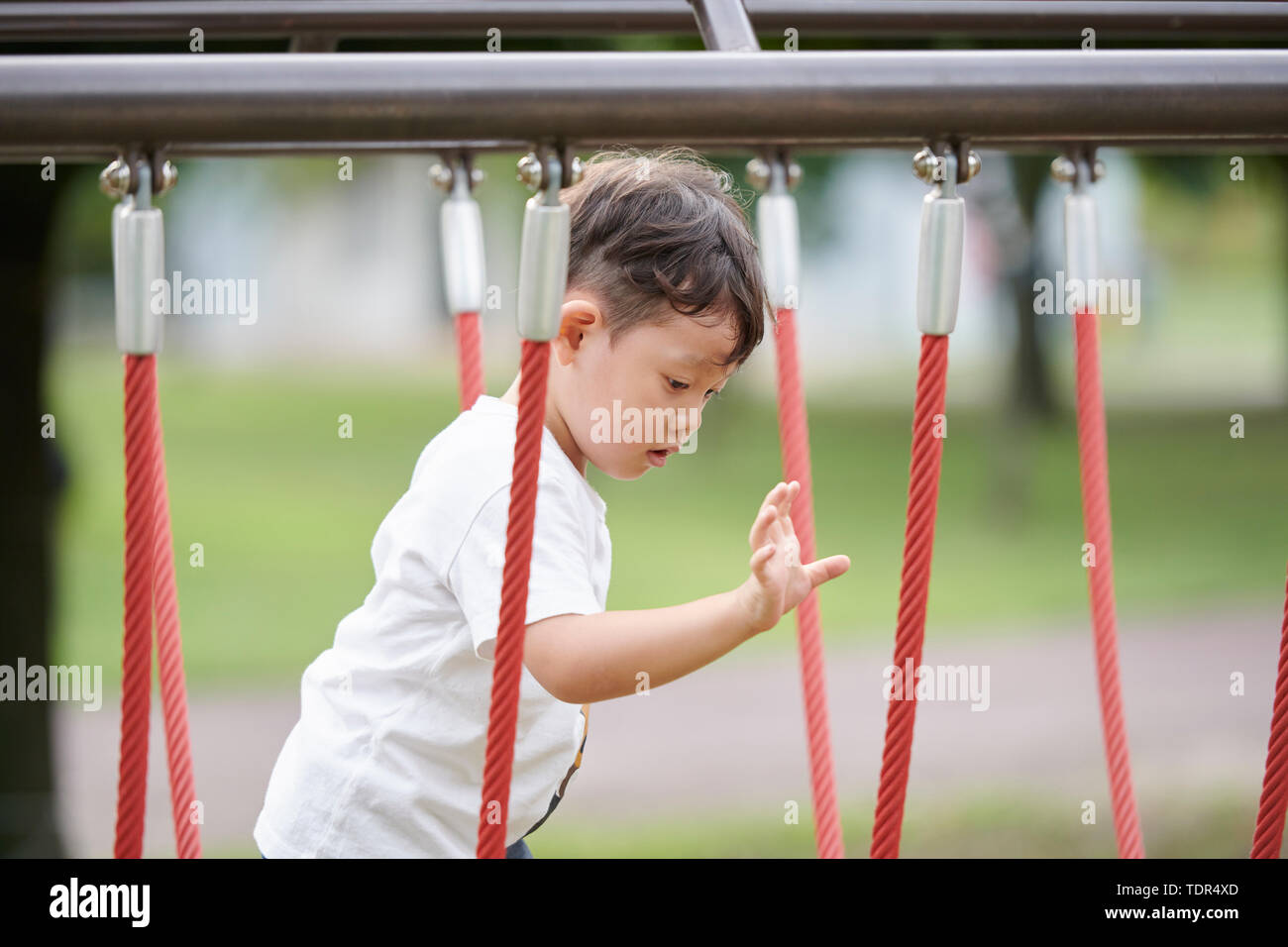 Japanese kid in a city park Stock Photo