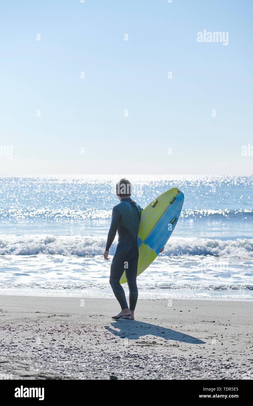 Japanese surfer at the beach Stock Photo