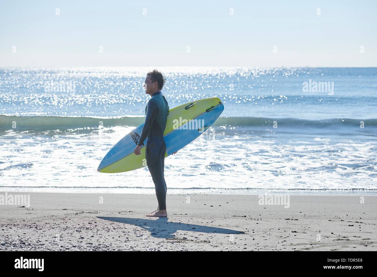 Japanese surfer at the beach Stock Photo