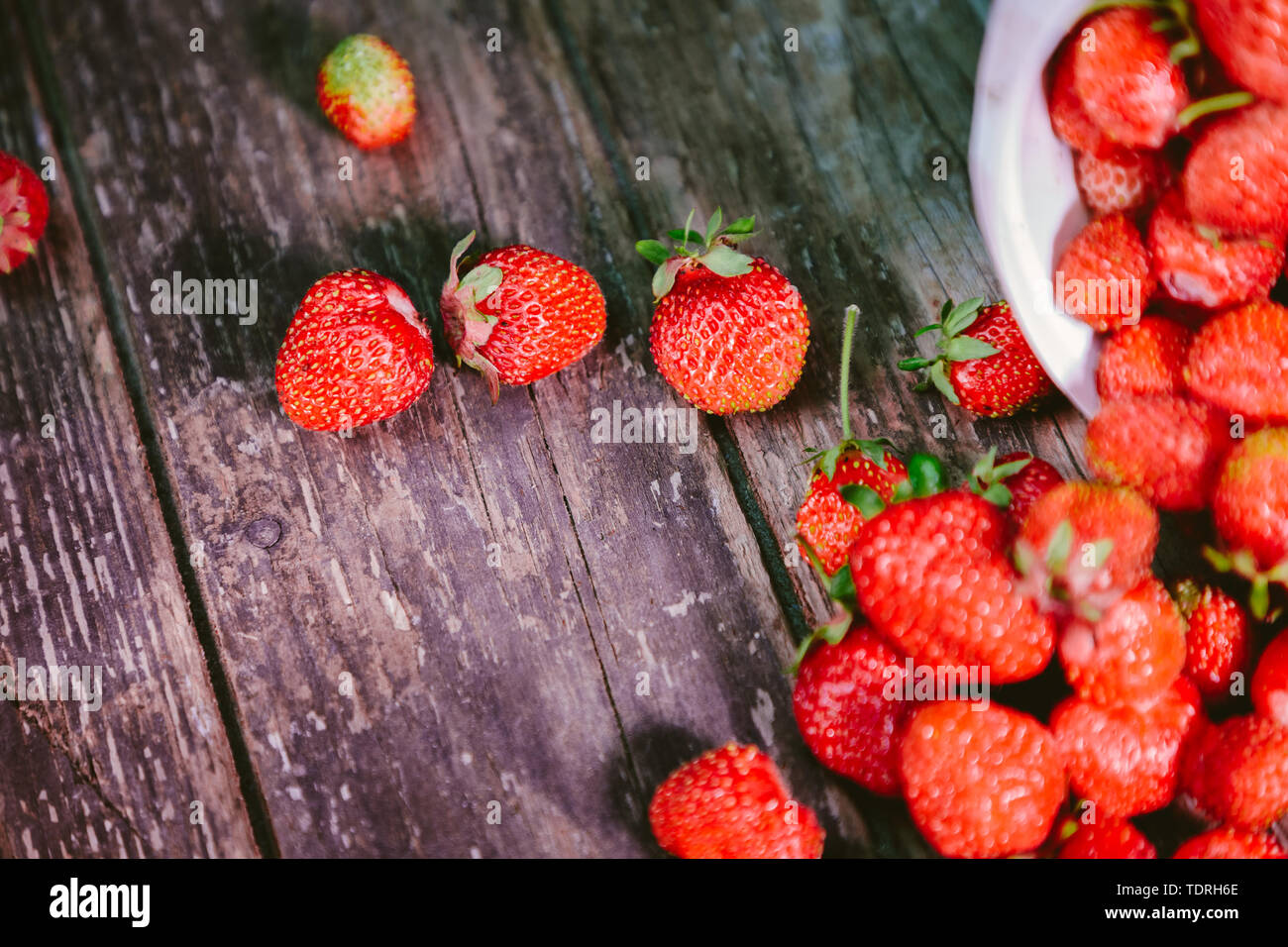 sprinkled natural and fresh strawberry from a white bucket Stock Photo ...