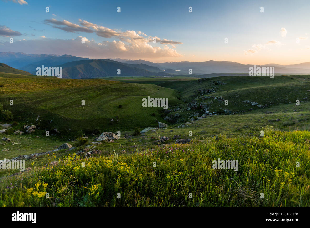 landscape of green hills and mountains and clouds Stock Photo