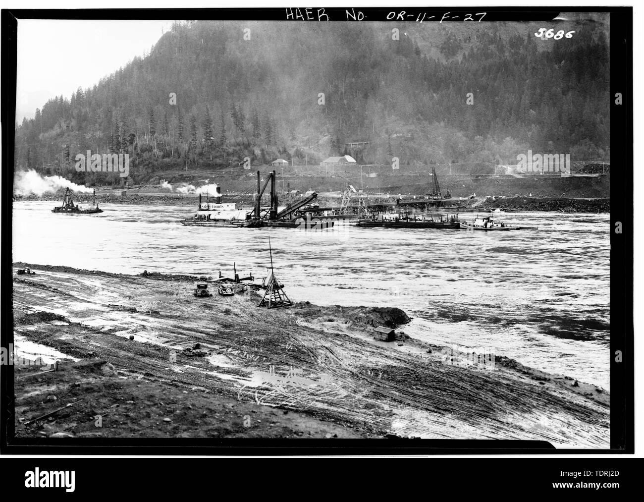 photographer unknown undated DREDGING OVERBURDEN FROM CRIB EXCAVATION AREAS IN MAIN CHANNEL FOR FIRST STEP COFFERDAM. BRADFORD ISLAND IN BACKGROUND. - Bonneville Project, Bonneville Dam, Columbia River, Bonneville, Multnomah County, OR Stock Photo