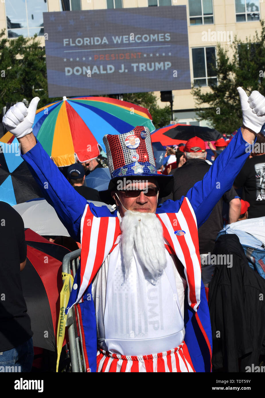 Orlando, Florida, USA. 18th June, 2019. A supporter of U.S. President Donald Trump dressed as Uncle Sam waits in line for a Make America Great Again rally at the Amway Center on June 18, 2019 in Orlando, Florida. The rally is billed as Trump's kick-off event for his campaign for re-election in 2020. (Paul Hennessy/Alamy) Credit: Paul Hennessy/Alamy Live News Stock Photo